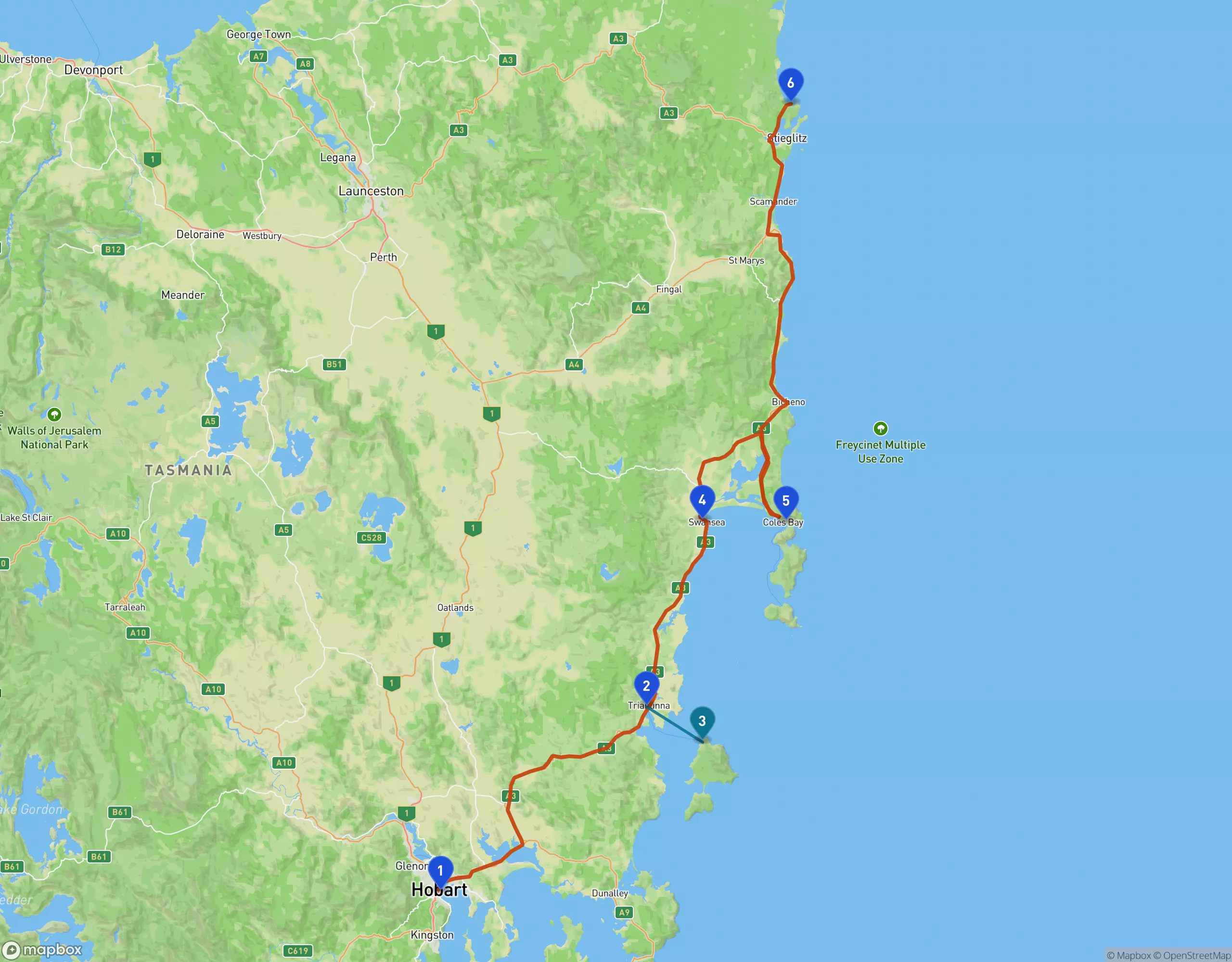 Topographic map of eastern Tasmania showing a four-day drive up the east coast. A terracotta line runs from Hobart, marked 1, northeast through farmland to Triabunna, marked 2, where a short teal line crosses the water to Maria Island, marked 3. The terracotta route continues north along the coast past Swansea, marked 4, out to Coles Bay on the Freycinet Peninsula, marked 5, then north through Bicheno and St Marys to Binalong Bay at the Bay of Fires, marked 6.