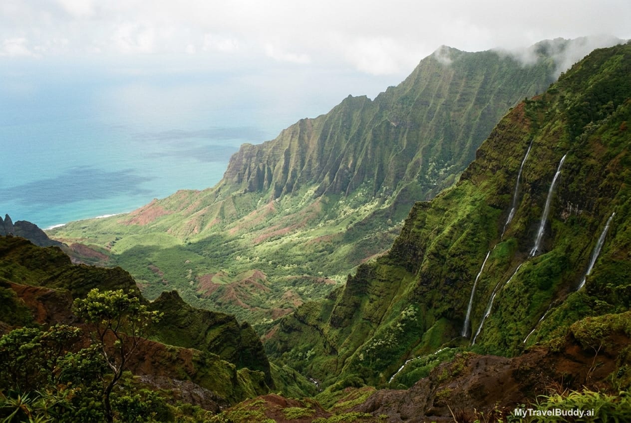 Lush Kauaʻi cliffs and valley greenery after rain, with ocean light beyond.