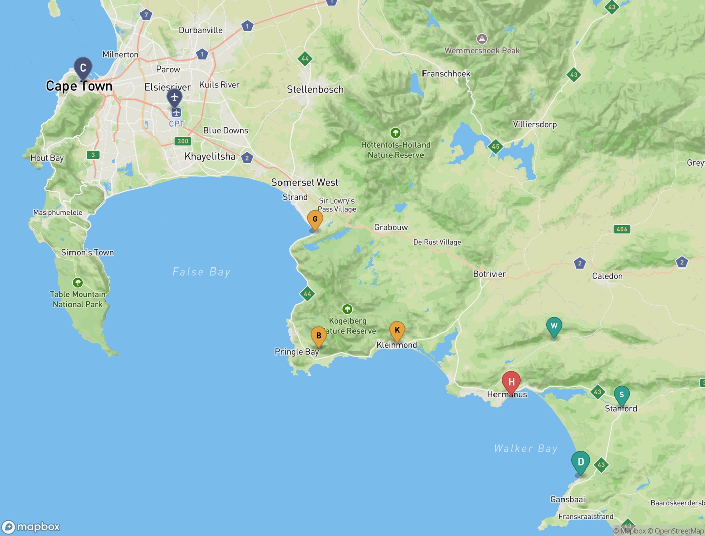 Regional map from Cape Town east around False Bay to Walker Bay, with pins for Cape Town, the airport, Gordon’s Bay, Betty’s Bay, Kleinmond, Hermanus, the Hemel-en-Aarde valley, Stanford and De Kelders.